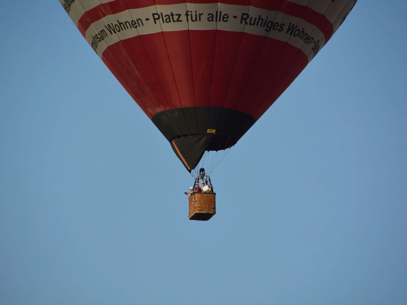 Passengers in a hot-air balloon basket at first light
